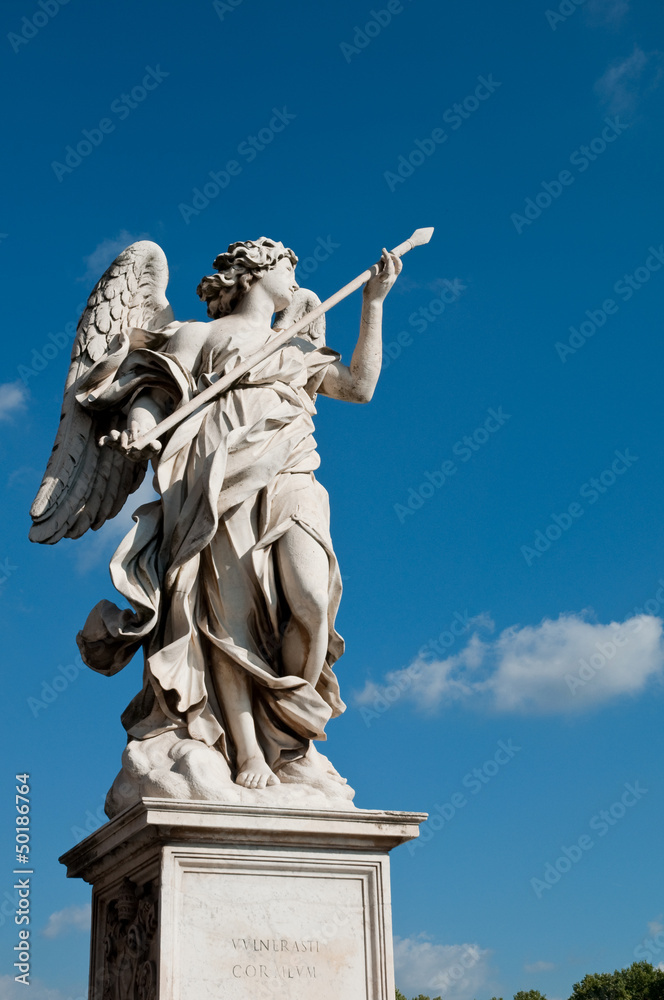 Statue at Sant Angello bridge on blue sky at Rome