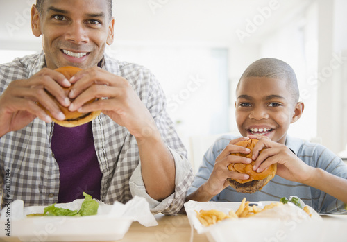 Father and son eating hamburgers photo