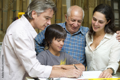 Hispanic family in carpentry workshop photo