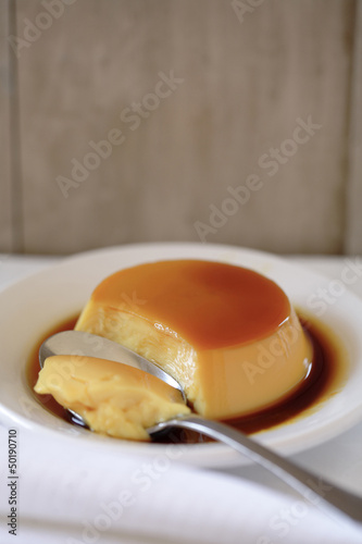 Flan on plate with spoon