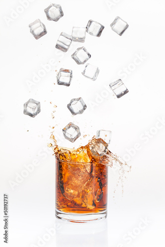 Ice cubes splashing bourbon