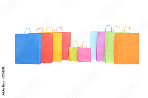 Many colorful shopping bags on a table