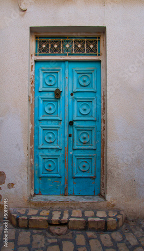 Traditional entrance blue door in Tunisia