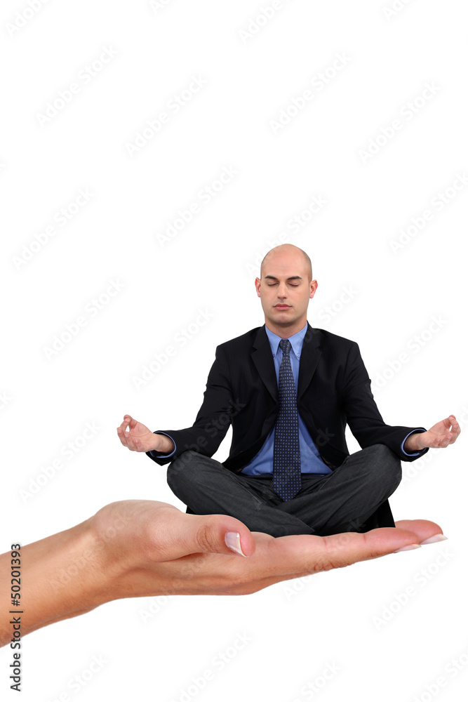 Bald businessman sat in yoga position Bald businessman sat in yoga position