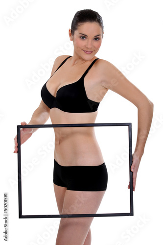 Woman in underwear holding blank picture frame