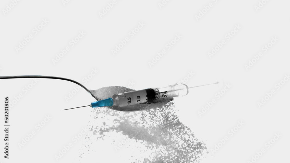Syringe falling onto spoon full of sugar