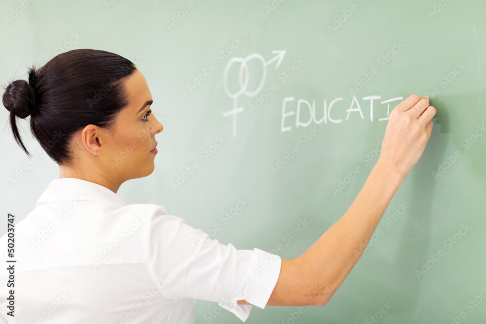 educator writing sex education on chalkboard educator writing sex education on chalkboard
