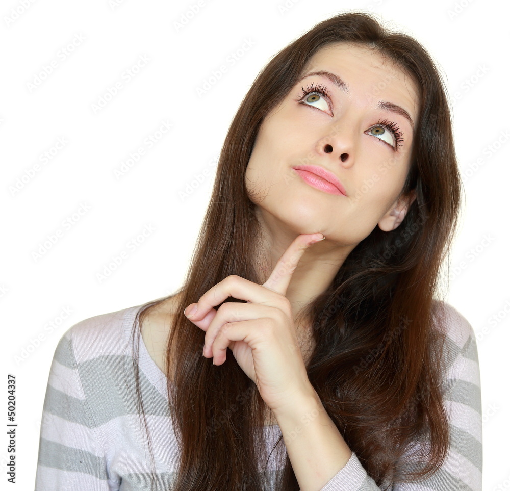 Thinking girl looking up with finger at face with smile isolated Thinking girl looking up with finger at face with smile isolated