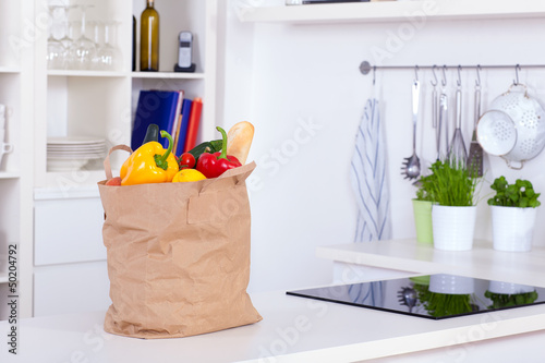 Paper shopping bag full of food