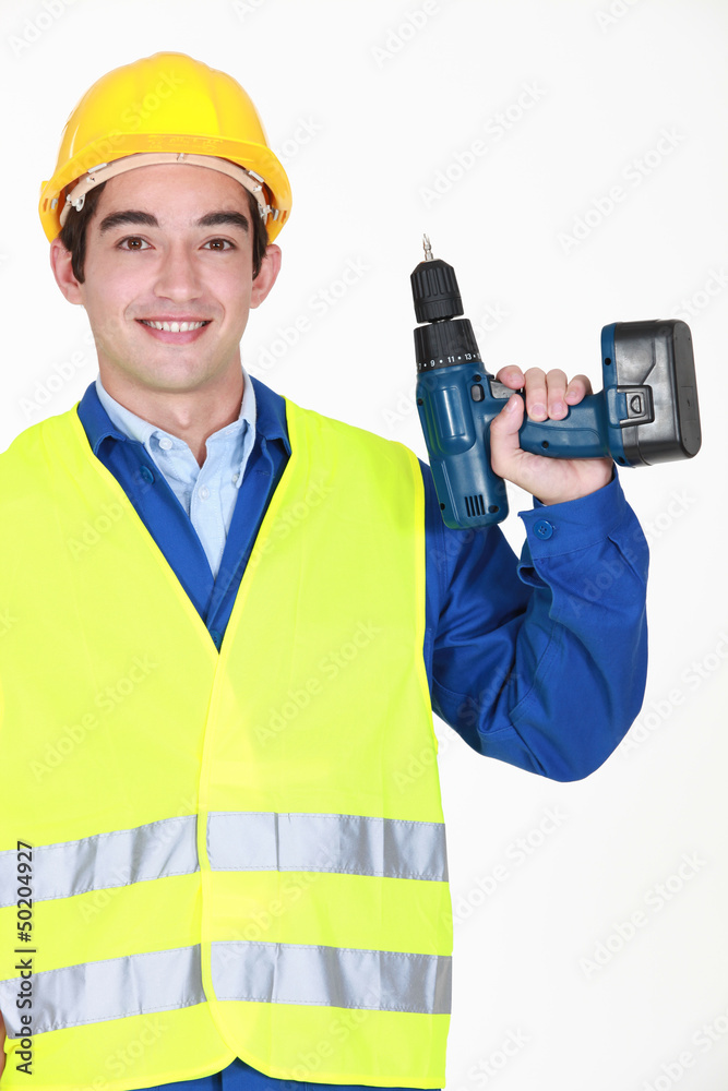 A handyman with a drill. A handyman with a drill.