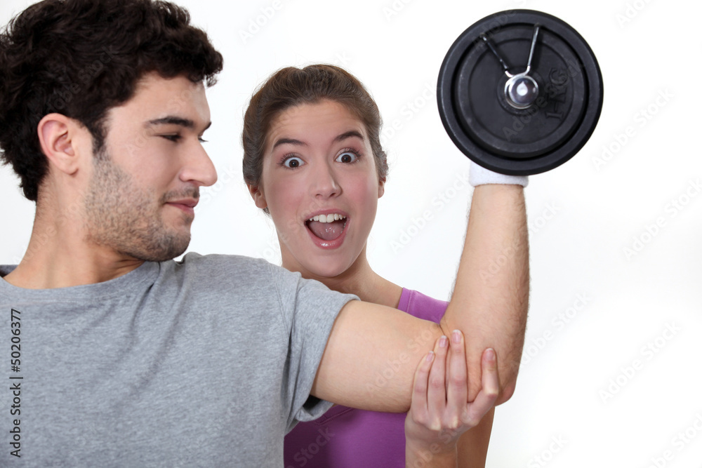 Man showing off in front of his girlfriend. Man showing off in front of his girlfriend.