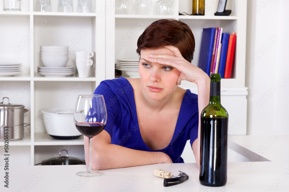young sad thinkful woman drinking a glass of red wine young sad thinkful woman drinking a glass of red wine