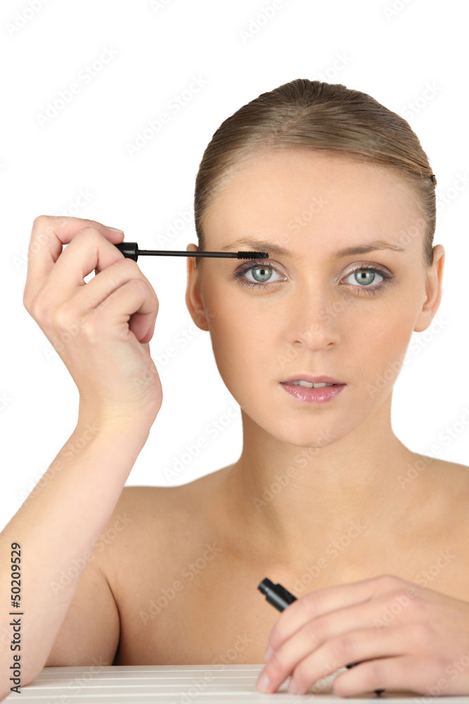 Woman putting some make-up on Woman putting some make-up on