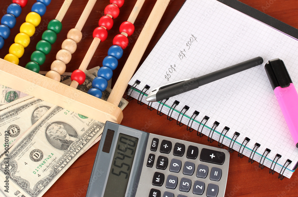 Bright wooden abacus and calculator.Conceptual photo of old and Bright wooden abacus and calculator.Conceptual photo of old and