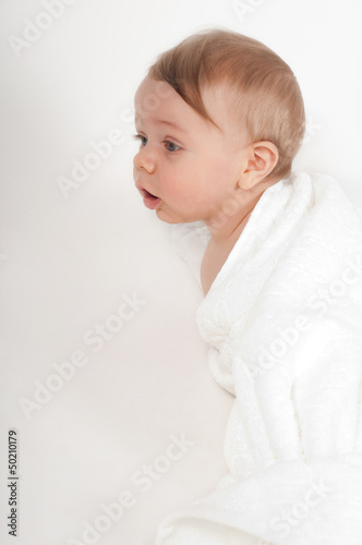 Little boy in white blanket