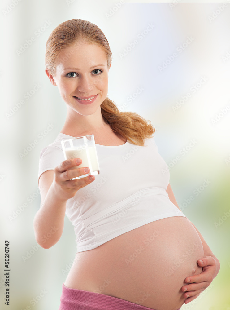 beautiful young pregnant woman and glass of milk beautiful young pregnant woman and glass of milk