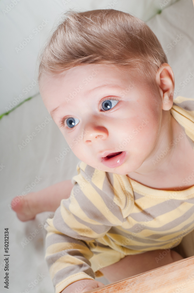Little cute baby boy in striped clothes Little cute baby boy in striped clothes