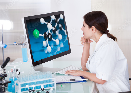 Female Scientist Looking On Computer Screen