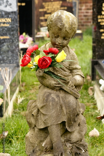 infant child statue grave stone in cemetery photo
