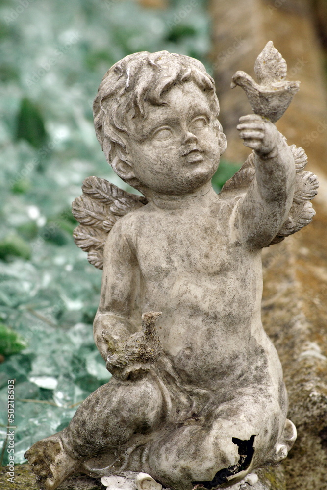 stone cherub angel gravestone at cemetery