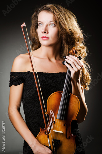 Woman performer with violin in studio