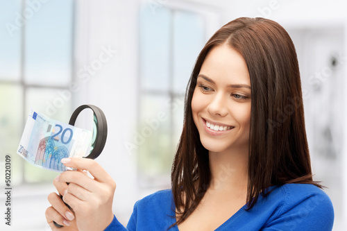 woman with magnifying glass and euro cash money