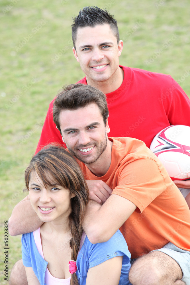 Young people playing soccer in a park Young people playing soccer in a park