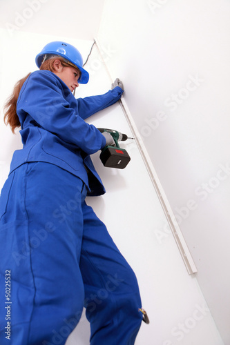 Woman screwing a molding