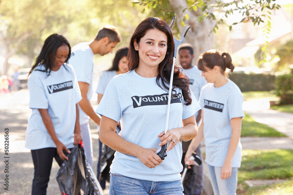 Team Of Volunteers Picking Up Litter In Suburban Street Team Of Volunteers Picking Up Litter In Suburban Street