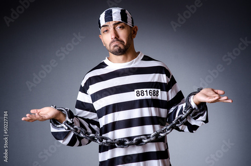 Convict criminal in striped uniform © Elnur