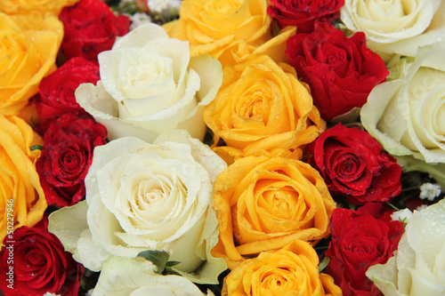 yellow  white and red roses in a wedding arrangement