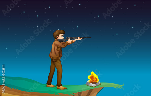 A boy with a gun at the cliff with a campfire