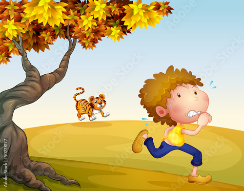 A boy running with a tiger at his back