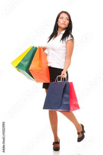 Full length of happy young lady shopping bags against isolated