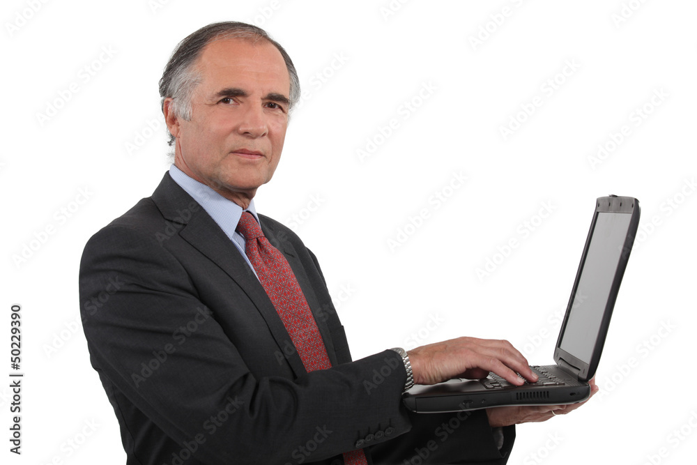 A mature businessman with a laptop. A mature businessman with a laptop.
