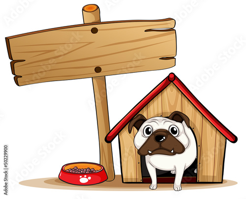A signboard beside a doghouse with a dog