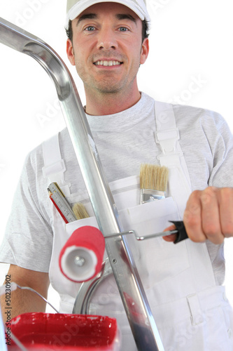 Man painting a wall red photo