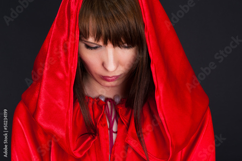 beautiful woman in a red robe humbly pray