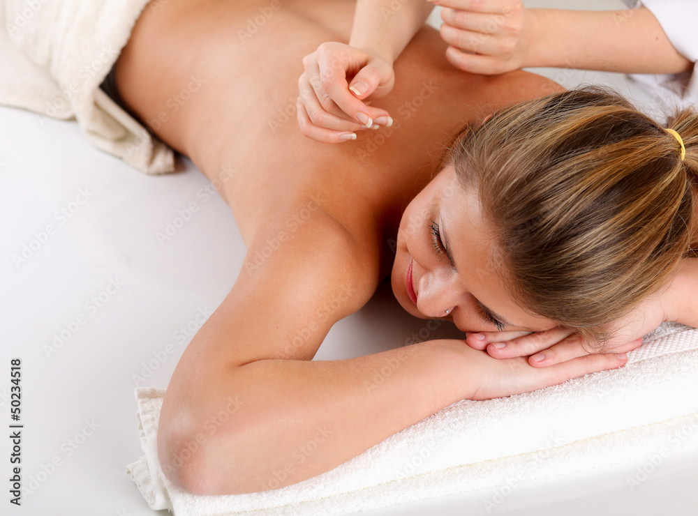 Closeup of an attractive young woman receiving massage Closeup of an attractive young woman receiving massage
