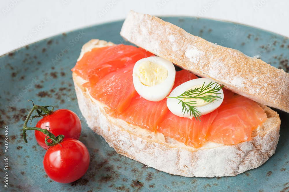 Sandwich with salmon, eggs and fresh tomatoes Sandwich with salmon, eggs and fresh tomatoes