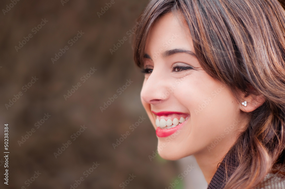 Profile portrait of a young woman smiling Profile portrait of a young woman smiling