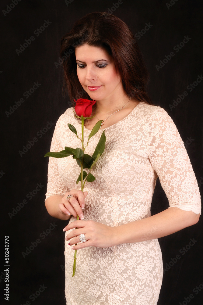 Woman with rose posing in studio Woman with rose posing in studio