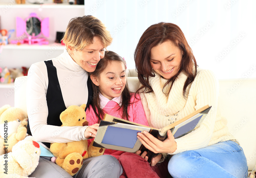 Grandmother, mother, and daughter reading a book Grandmother, mother, and daughter reading a book