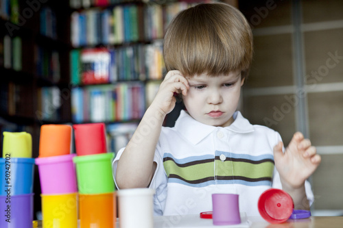 Little boy creating toys from playdough