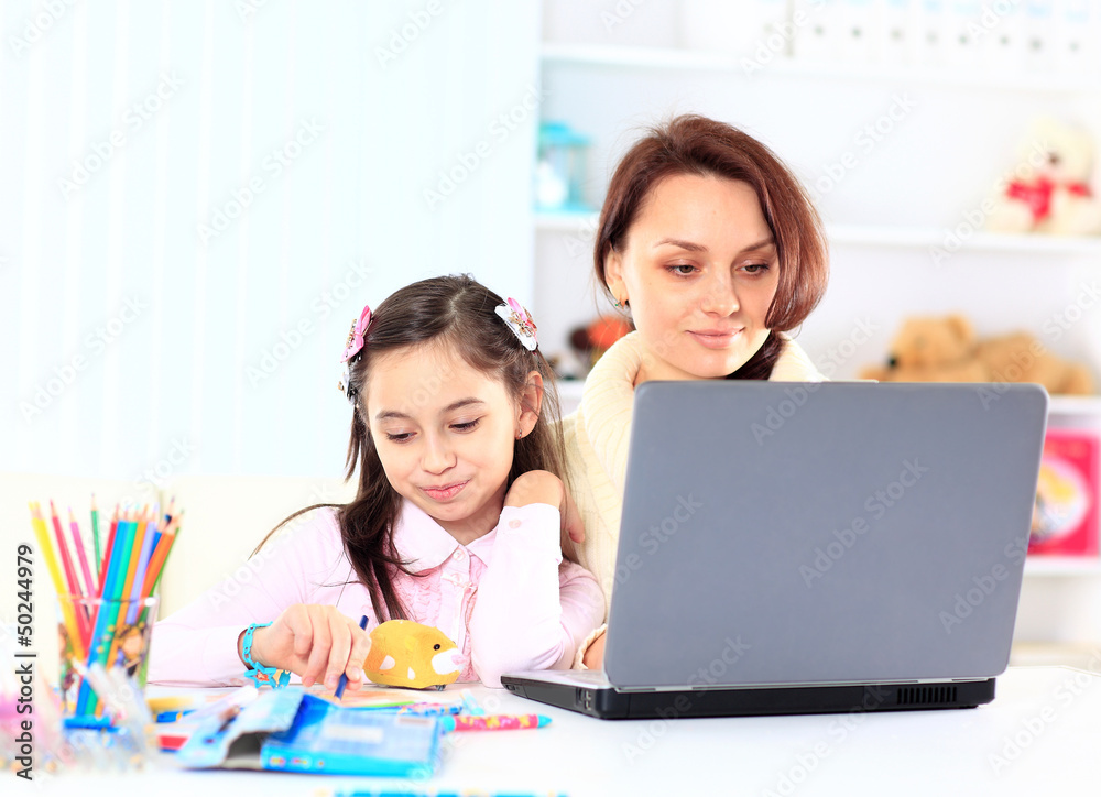 Young mother with little daughter sitting together Young mother with little daughter sitting together