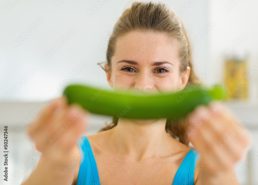 Young woman smiling with zucchini Young woman smiling with zucchini