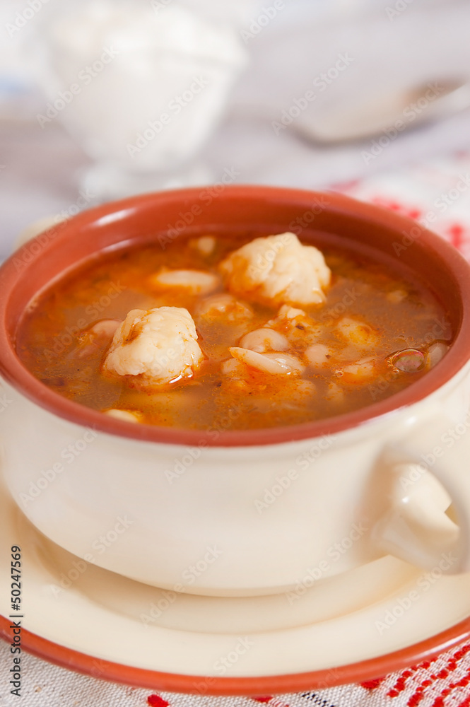 Soup with beans and dumplings in soup bowl Soup with beans and dumplings in soup bowl