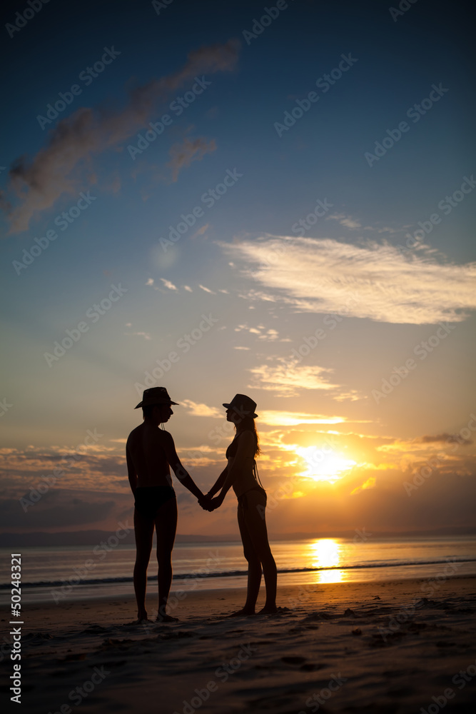 Pretty couple on the sunset background