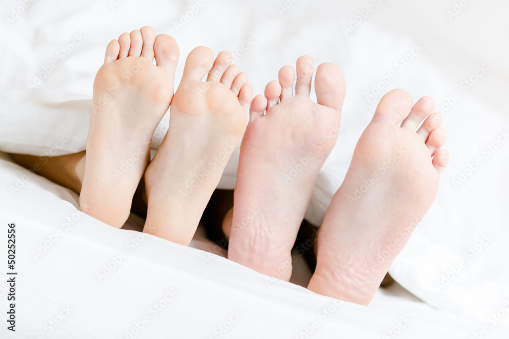Close up of two pairs of feet of the couple next to each other