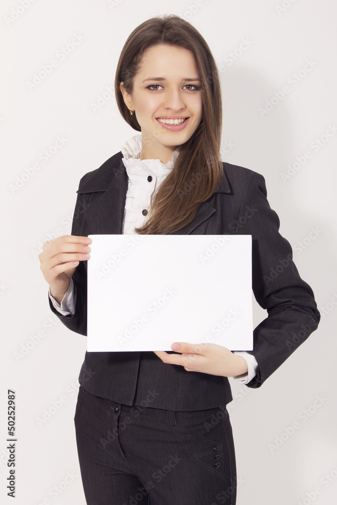 Beautiful young business woman holding blank paper card smiling Beautiful young business woman holding blank paper card smiling